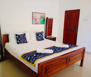 a bed in a room with two towels on it at Sampath Grand Hotel in Mawanella +13 photos