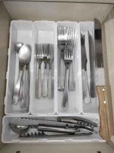 a drawer filled with forks and spoons and utensils at Casa Paraíso Piscina Aquecida e Pet Friendly in Sinop