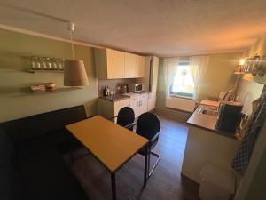 a small kitchen with a table and chairs in a room at Gästehaus Graupner in Hainichen