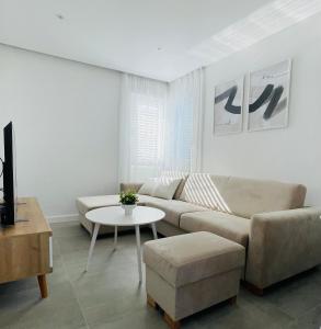 a living room with a couch and a table at Apartmani Villa Antea in Klek