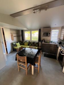 a kitchen and living room with a table and chairs at VI05 Village 05 in Vias +5 photos