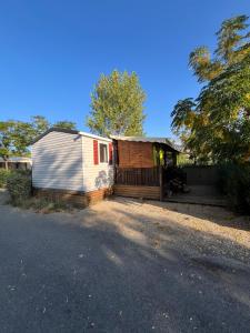 a small house with a porch next to a driveway at VI05 Village 05 in Vias