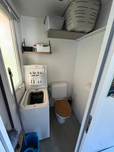 a small kitchen with a stove and a toilet at VI05 Village 05 in Vias