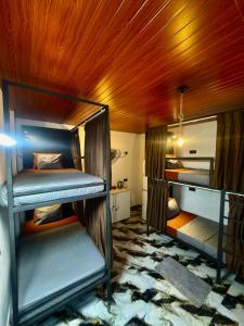 a room with two bunk beds and a wooden ceiling at A Lounge Hostel in Ella +101 photos