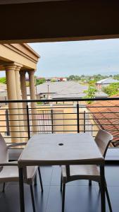 a table and chairs on a balcony with a view at Dakarai B & B in Thulamahashi