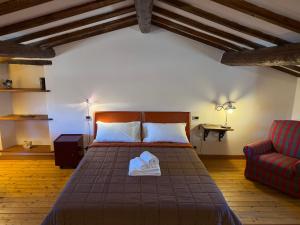 a bedroom with a bed and a red couch at Campanile N1 in Montemerano