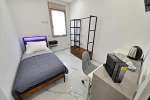 a small bedroom with a bed and a tv at Gioia e Relax di ZR in Rho +7 photos