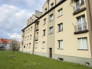 a large building with a grass field next to it at Helenka Loft House 24H - Zabrze blisko A1, Arena Gliwice 15 min in Zabrze