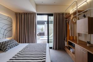 a bedroom with a bed with a black and white rug at Noera in Skiathos