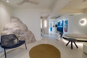 a room with a table and a rock on the wall at Noera in Skiathos