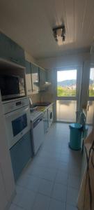 a kitchen with white appliances and a large window at Cannes Park in Cannes