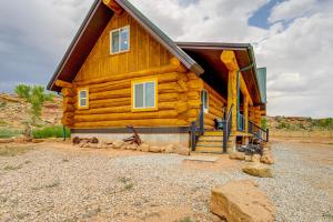 a log cabin with a staircase in front of it at 'Rustic Cliff Ranch' in Uintah Basin: Dogs Welcome in Fort Duchesne