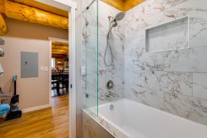 a bathroom with a shower and a tub at 'Rustic Cliff Ranch' in Uintah Basin: Dogs Welcome in Fort Duchesne +37 photos