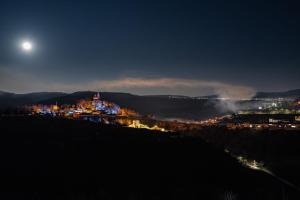 a city at night with the moon in the sky at House 46 in Veliko Tŭrnovo