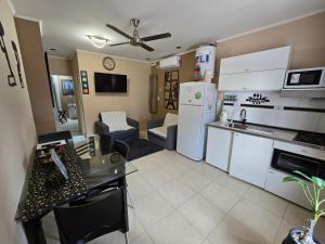 a kitchen and living room with a white refrigerator at Temporario VaSan con cochera in Corrientes