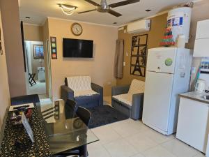 a kitchen and living room with a refrigerator and chairs at Temporario VaSan con cochera in Corrientes