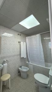 a bathroom with a toilet and a sink and a tub at Hotel Congra in Pilar de la Horadada +35 photos