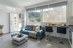 a living room with a couch and a table at Basil Leaf - Minimal View Retreat in Gonia