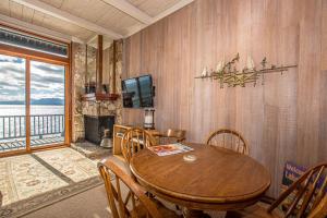a dining room with a table and chairs and a television at Star Harbor # 13 By Hauserman Rentals in Tahoe City