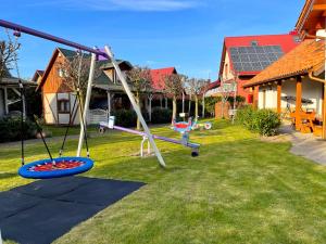 a swing set in the yard of a house at AchKaszuby domki nad morzem in Puck
