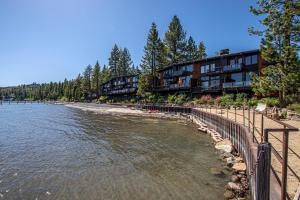 a building on the shore of a beach with water at Star Harbor # 13 By Hauserman Rentals in Tahoe City