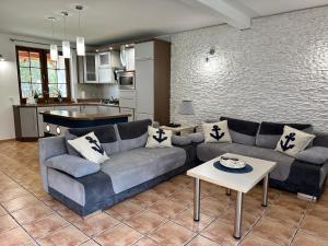 a living room with a couch and a table at AchKaszuby domki nad morzem in Puck