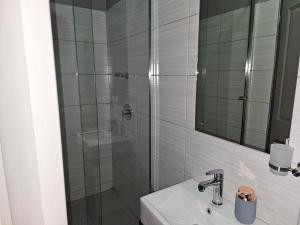 a bathroom with a shower and a sink at Sky Apartment Mbabane CBD in Mbabane