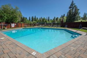 a large swimming pool with blue water in a yard at Star Harbor # 13 By Hauserman Rentals in Tahoe City