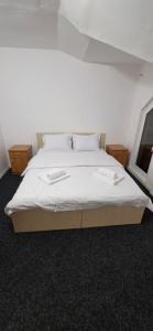 a bed with white sheets and pillows in a room at Pensiune Urban in Borsec +19 photos