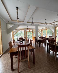 a dining room with wooden tables and chairs at Montvale Resort in Pasu