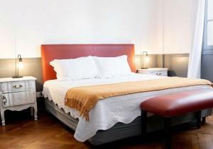 a bedroom with a large bed and two night stands at Moreno 820 by DOT Suites in Buenos Aires