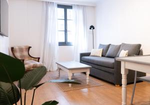 a living room with a couch and a table at Moreno 820 by DOT Suites in Buenos Aires
