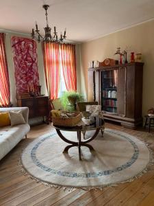 a living room with a couch and a coffee table at Gutshaus Schwarzenhof in Dargun