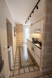 a kitchen with a rug on the floor at Bari LandLord 71 - Private Balcony Suites in Bari