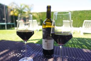 two glasses of red wine sitting on a table at Casas do Maranhão Póvoa de Varzim in Navais