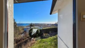 a window view of the ocean from a house at Ferienwohnungen Meerblick Herde in Göhren