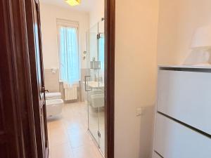 a bathroom with a toilet and a glass door at Terrazza Portovenere in Le Grazie +25 photos