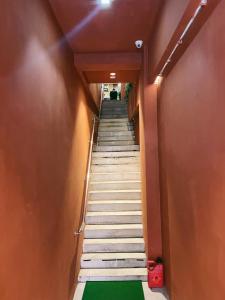 a stairway leading up to a building with a green floor at BlackView in Kota Kinabalu