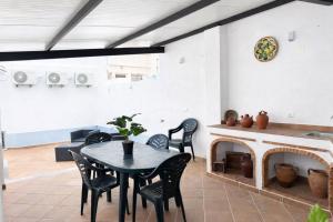 a dining room with a table and a fireplace at O Cantinho dos Avós in Mourão