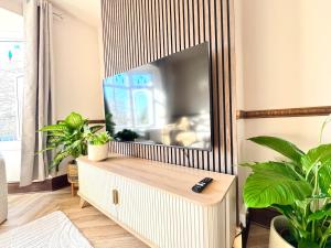 a living room with a large mirror and a fish tank at Shrubbery Lodge - Games Room & Patio Dining in Wyke Regis +21 photos