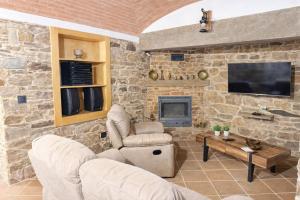 a living room with a stone wall at O Cantinho dos Avós in Mourão