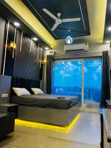 a bedroom with a bed and a large window at Unique property in Ghaziabad