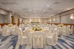 a banquet hall with white tables and chairs with flowers at Comfort Inn & Suites Rapid City near Mt Rushmore in Rapid City +94 photos