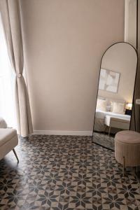 a bedroom with a mirror and a bed at Bari LandLord 71 - Private Balcony Suites in Bari