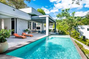 a swimming pool in the backyard of a house at La Villetta in Ostional