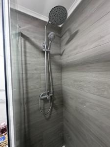 a shower with a shower head in a bathroom at Rooms Moscavide quartos in Lisbon +40 photos