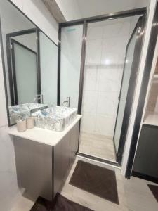 a bathroom with a shower and a sink at Malima Stay in Suva