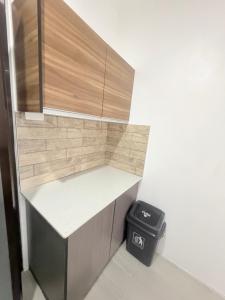 a small kitchen with a counter and a trash can at Malima Stay in Suva