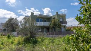 a house in the middle of a field at Basil Leaf - Minimal View Retreat in Gonia +18 photos