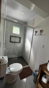 a small bathroom with a toilet and a shower at cabana refúgio in Paulo Lopes